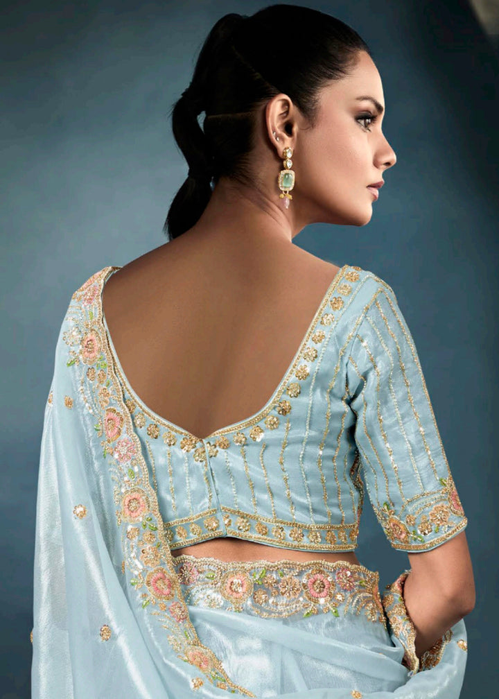 Radiant Blue tissue saree with intricate handwork & cutwork embroidery. Includes matching blouse piece. Perfect for wedding & festivals. Shop Now.