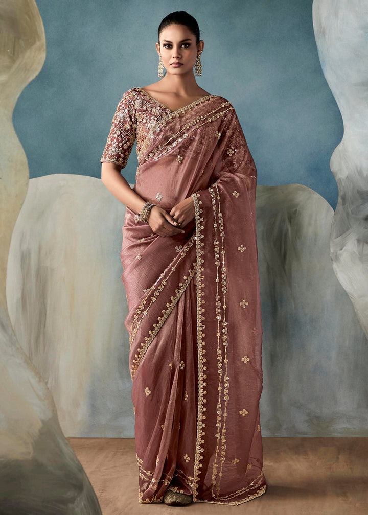 Radiant Mauve tissue saree with intricate handwork & cutwork embroidery. Includes matching blouse piece. Perfect for wedding & festivals. Shop Now.