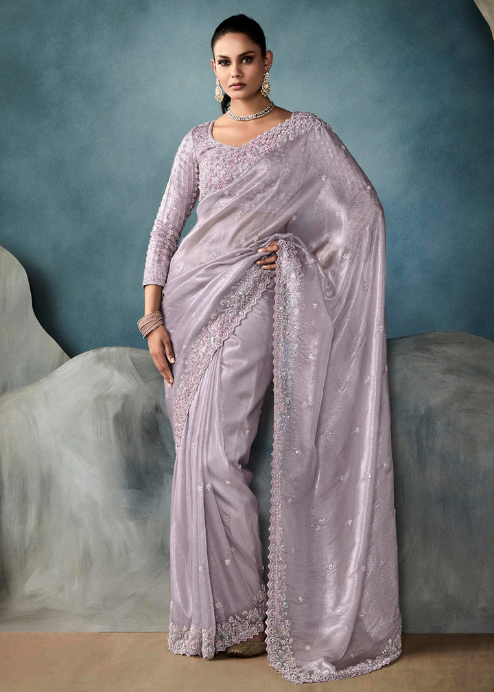 Radiant Lavender tissue saree with intricate handwork & cutwork embroidery. Includes matching blouse piece. Perfect for wedding & festivals. Shop Now.