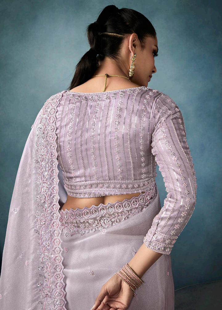 Radiant Lavender tissue saree with intricate handwork & cutwork embroidery. Includes matching blouse piece. Perfect for wedding & festivals. Shop Now.