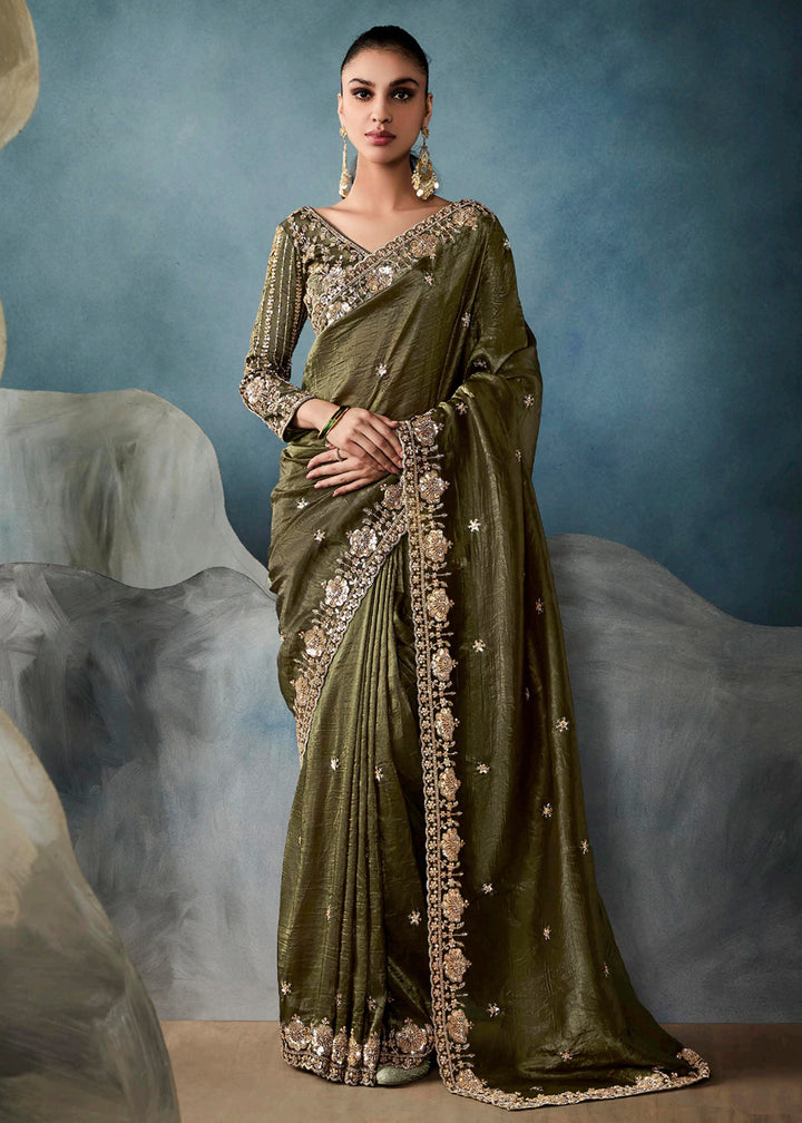 Radiant Green tissue saree with intricate handwork & cutwork embroidery. Includes matching blouse piece. Perfect for wedding & festivals. Shop Now.