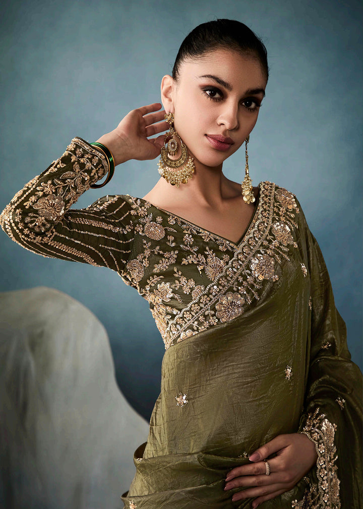 Radiant Green tissue saree with intricate handwork & cutwork embroidery. Includes matching blouse piece. Perfect for wedding & festivals. Shop Now.