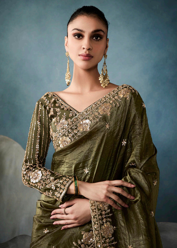 Radiant Green tissue saree with intricate handwork & cutwork embroidery. Includes matching blouse piece. Perfect for wedding & festivals. Shop Now.