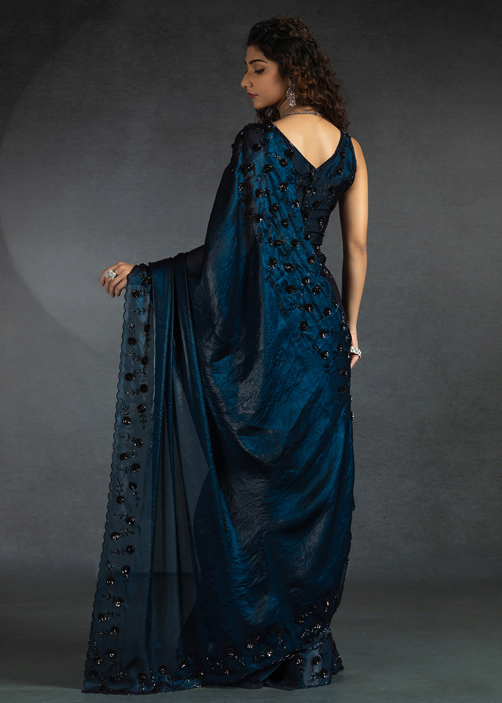 Gleaming Blue satin silk saree with intricate handwork, sequins, cutwork & zarkan embroidery. Includes matching blouse piece. Perfect for wedding parties.