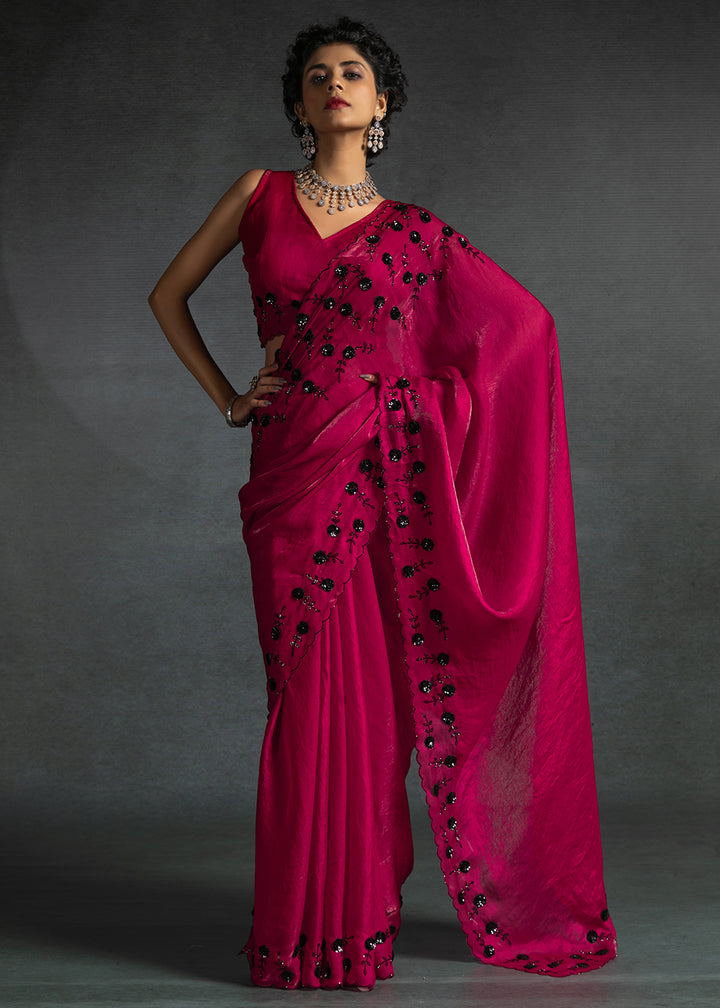 Gleaming Pink satin silk saree with intricate handwork, sequins, cutwork & zarkan embroidery. Includes matching blouse piece. Perfect for wedding parties.