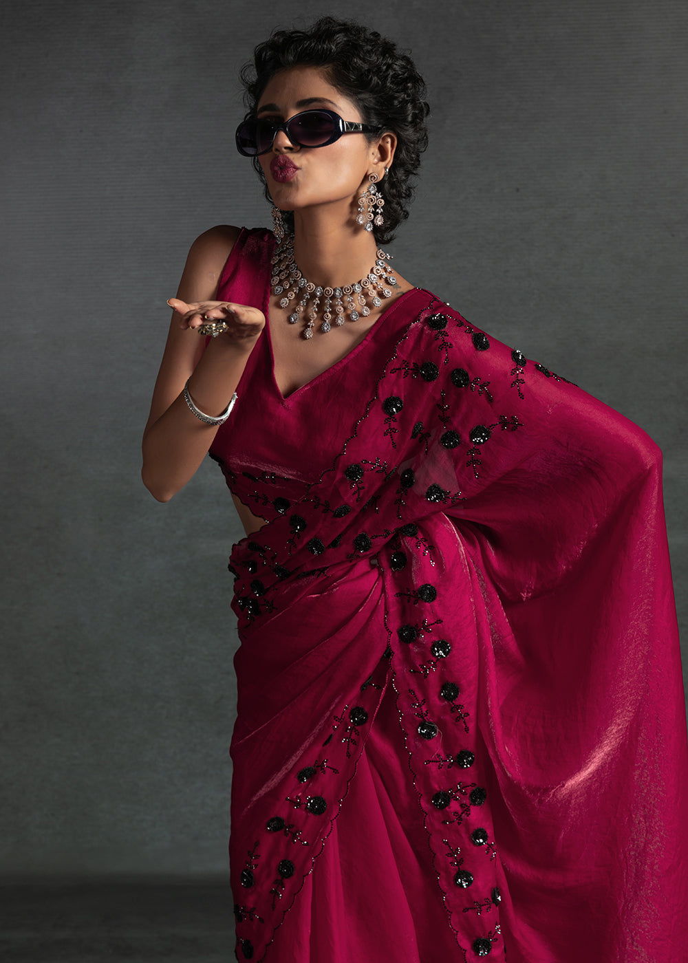 Gleaming Pink satin silk saree with intricate handwork, sequins, cutwork & zarkan embroidery. Includes matching blouse piece. Perfect for wedding parties.