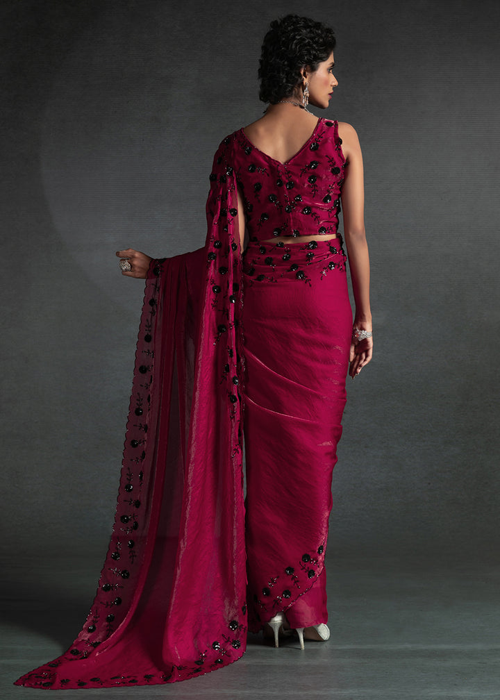 Gleaming Pink satin silk saree with intricate handwork, sequins, cutwork & zarkan embroidery. Includes matching blouse piece. Perfect for wedding parties.