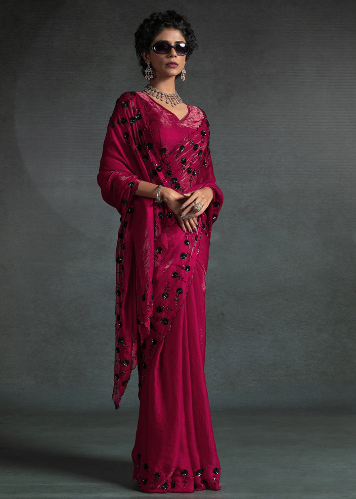 Gleaming Pink satin silk saree with intricate handwork, sequins, cutwork & zarkan embroidery. Includes matching blouse piece. Perfect for wedding parties.