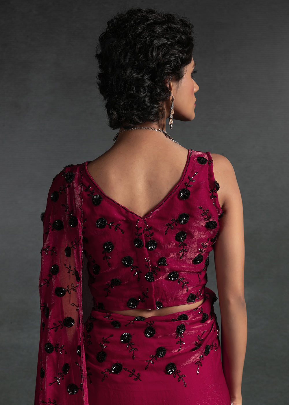 Gleaming Pink satin silk saree with intricate handwork, sequins, cutwork & zarkan embroidery. Includes matching blouse piece. Perfect for wedding parties.