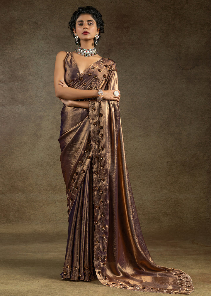 Luxurious golden satin silk saree with intricate handwork, sequins & zarkan embroidery. Includes matching blouse piece. Perfect for wedding parties. Buy now!