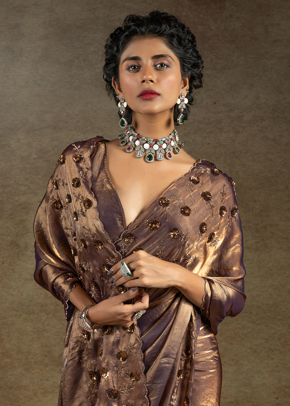 Luxurious golden satin silk saree with intricate handwork, sequins & zarkan embroidery. Includes matching blouse piece. Perfect for wedding parties. Buy now!