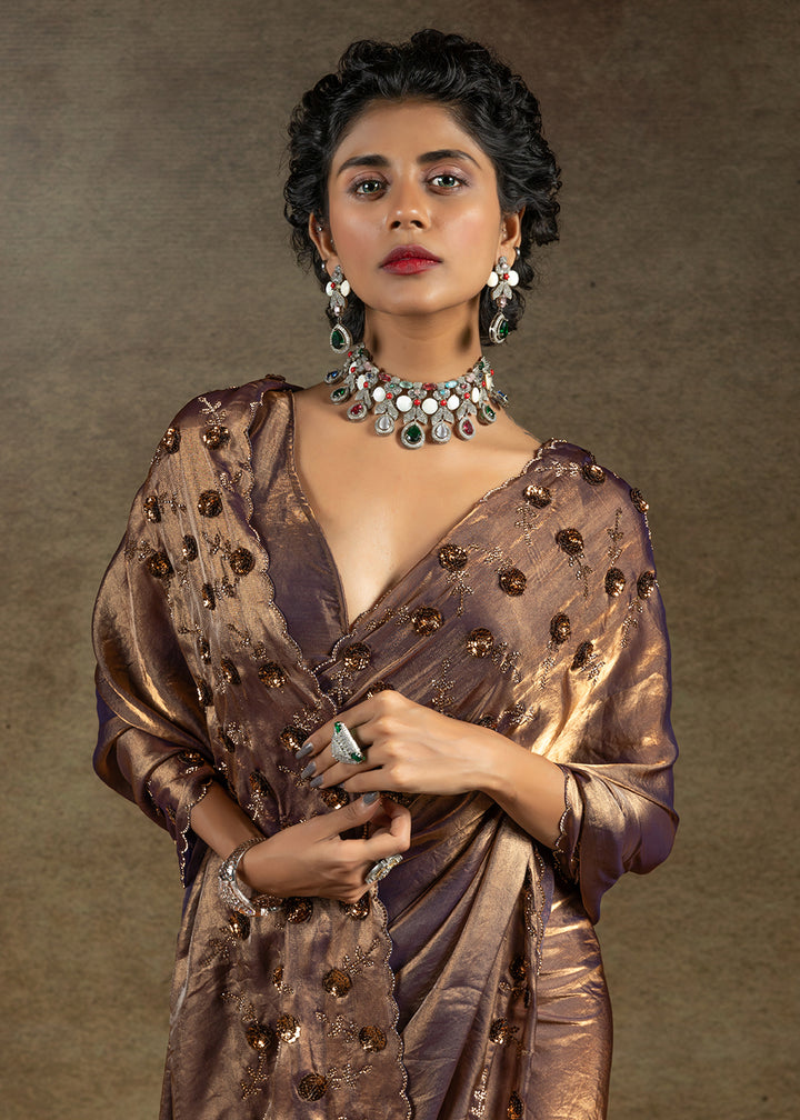 Luxurious golden satin silk saree with intricate handwork, sequins & zarkan embroidery. Includes matching blouse piece. Perfect for wedding parties. Buy now!