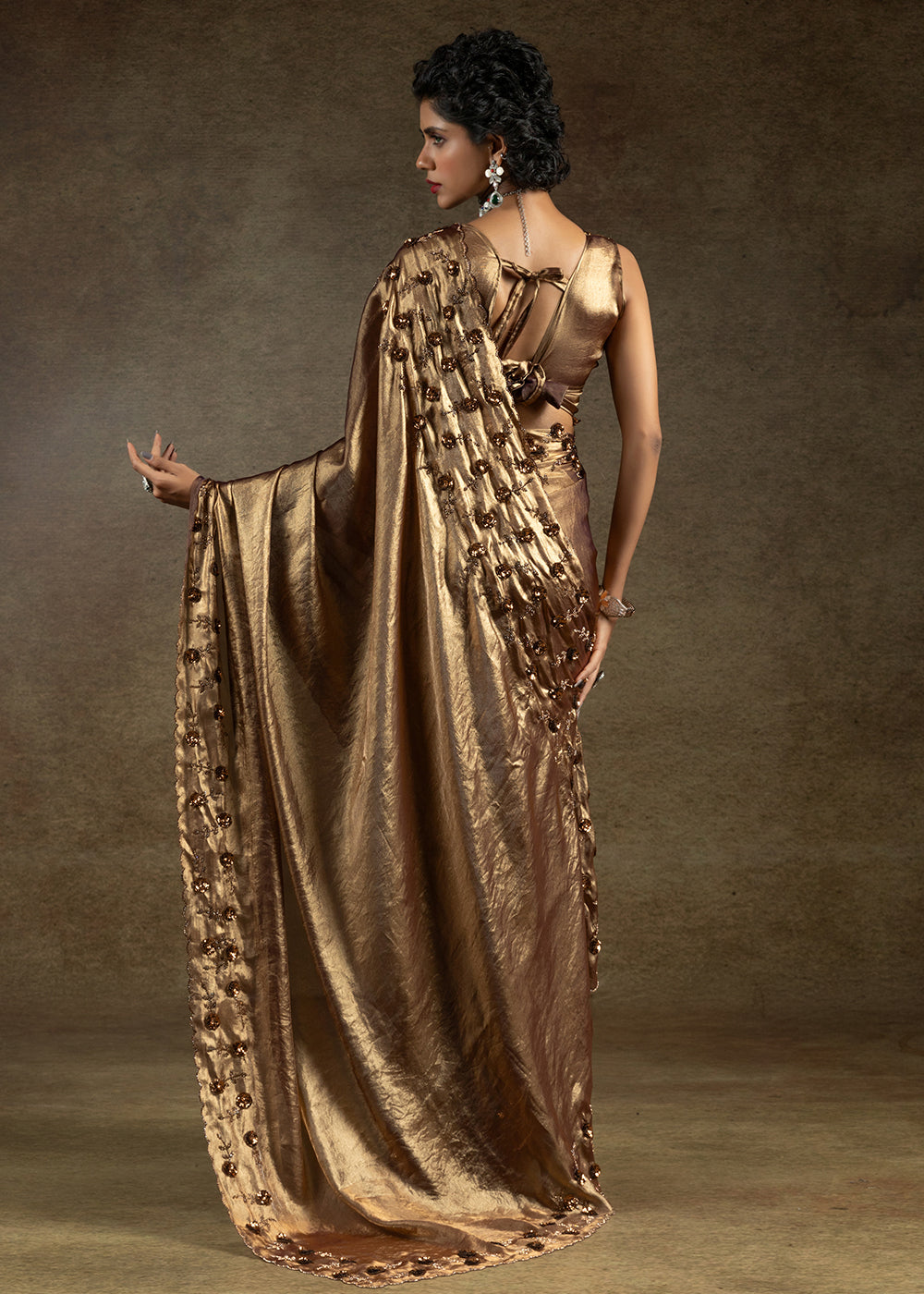 Luxurious golden satin silk saree with intricate handwork, sequins & zarkan embroidery. Includes matching blouse piece. Perfect for wedding parties. Buy now!