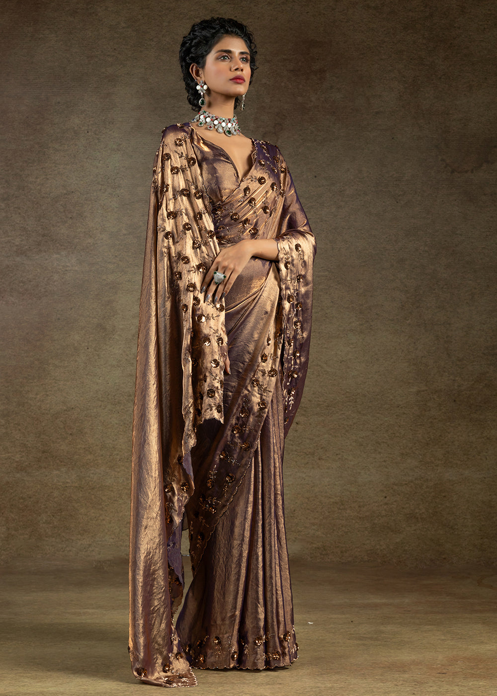 Luxurious golden satin silk saree with intricate handwork, sequins & zarkan embroidery. Includes matching blouse piece. Perfect for wedding parties. Buy now!
