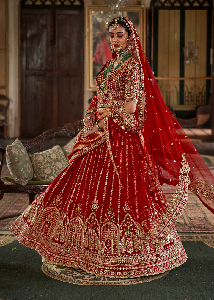Buy Now Cherry Red Sabyasachi Inspired Bridal Silk Lehenga Choli Online in US, UK, Canada, France, Italy, Germany, Austria, Denmark, UAE & Worldwide at Empress.