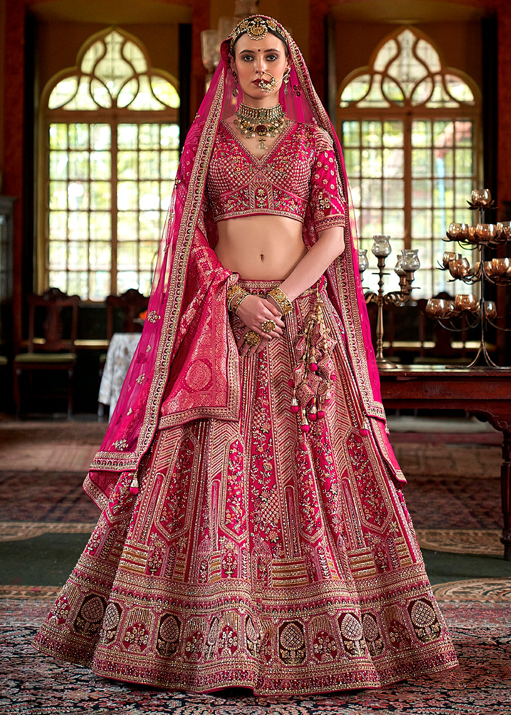 Buy Now Rani Pink Silk Heavily Embroidered Bridal Lehenga Choli Online in US, UK, Canada, France, Italy, Germany, Austria, Denmark, UAE & Worldwide at Empress.