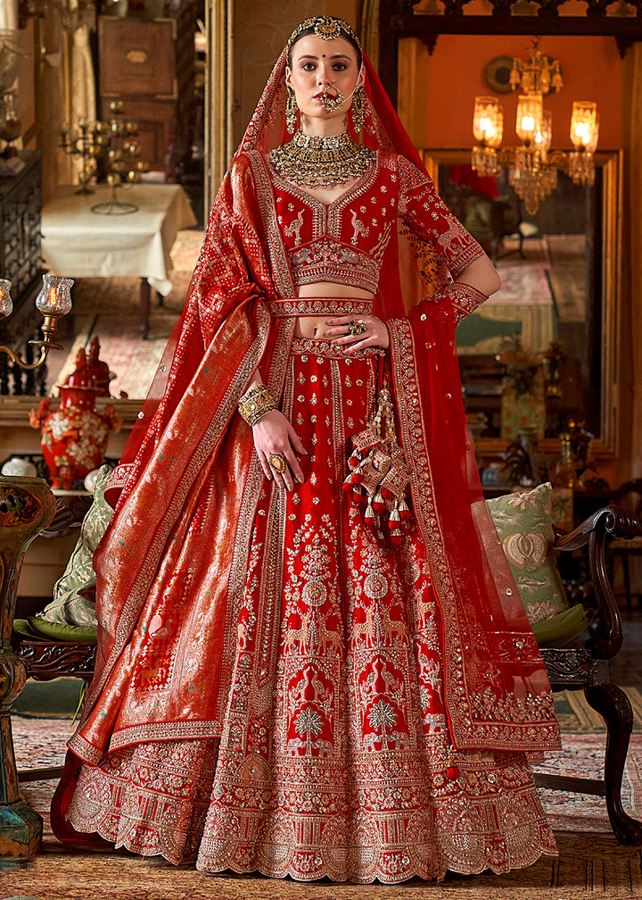 Buy Now Hot Red Silk Heavily Embroidered Bridal Lehenga Choli Online in US, UK, Canada, France, Italy, Germany, Austria, Denmark, UAE & Worldwide at Empress.