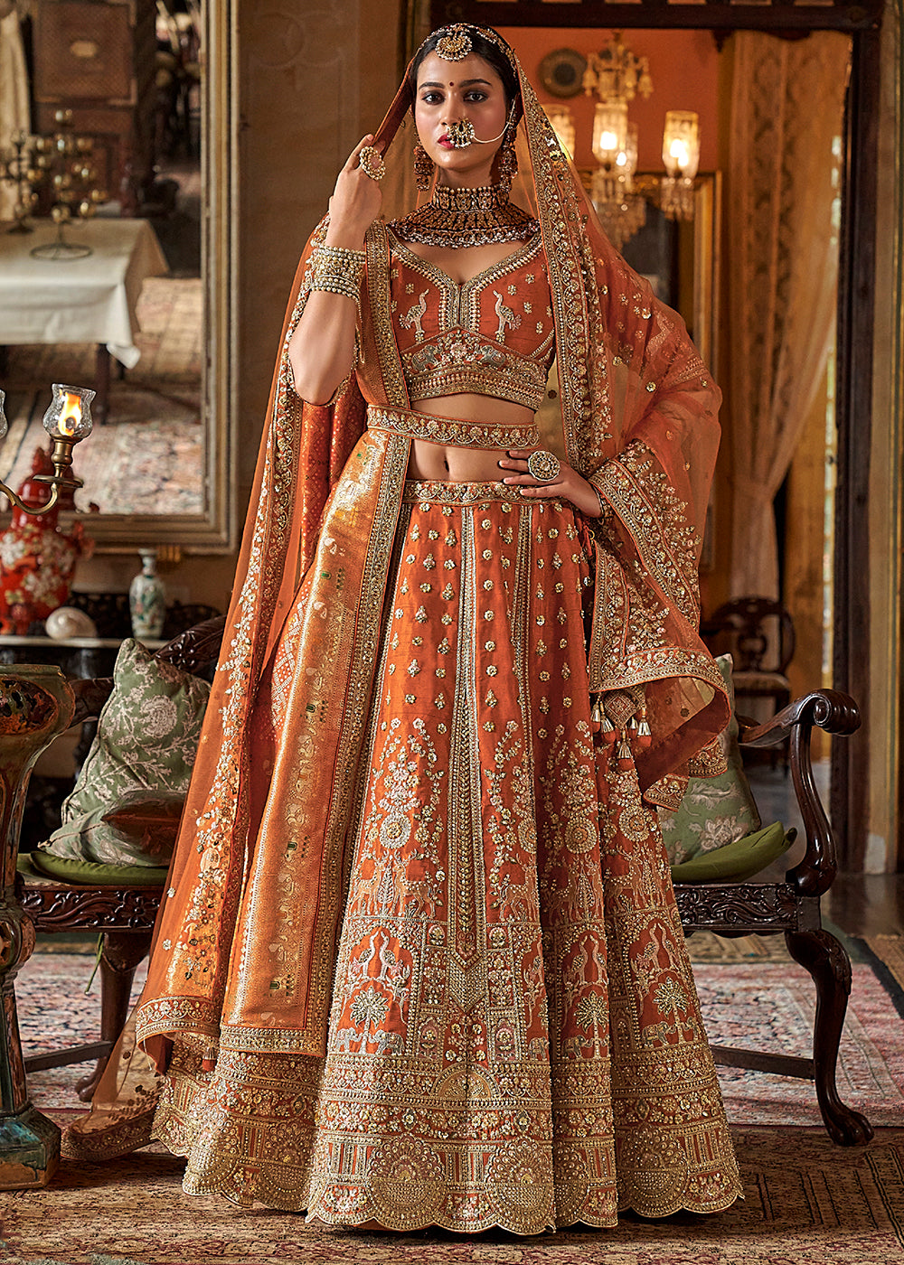 Buy Now Orange Silk Heavily Embroidered Bridal Lehenga Choli Online in US, UK, Canada, France, Italy, Germany, Austria, Denmark, UAE & Worldwide at Empress.