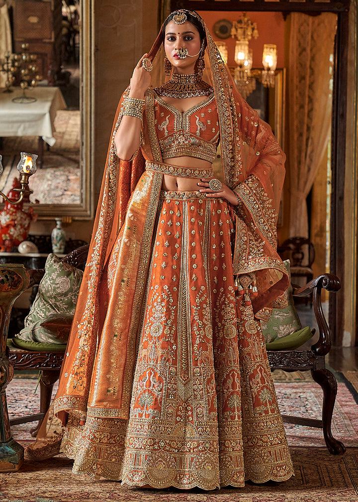 Buy Now Orange Silk Heavily Embroidered Bridal Lehenga Choli Online in US, UK, Canada, France, Italy, Germany, Austria, Denmark, UAE & Worldwide at Empress.