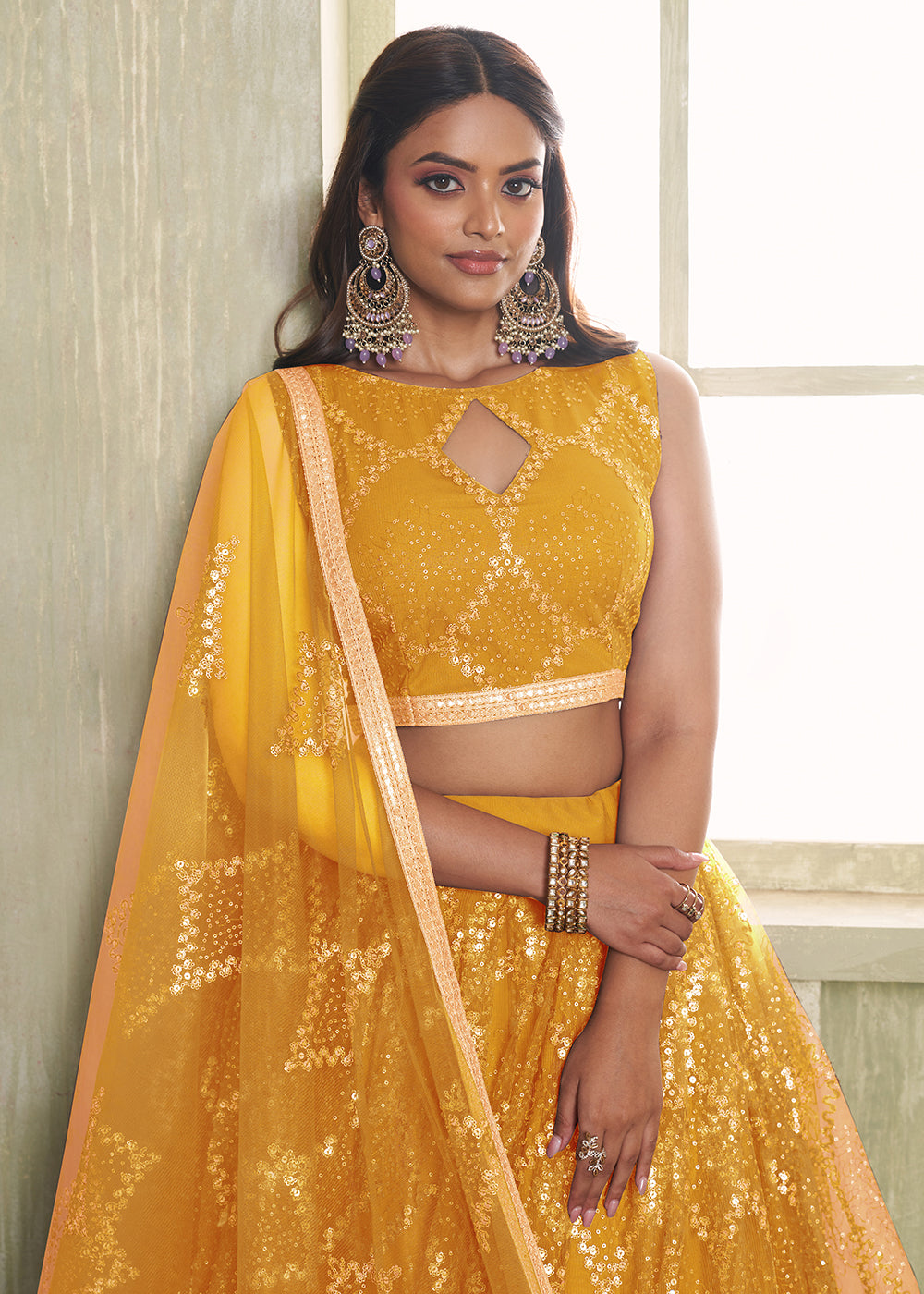 Buy Now Enchanting Mustard Net Wedding Festive Lehenga Choli Online in USA, UK, Canada, France, Italy, Germany, Sweden, Denmark &amp; Worldwide at Empress Clothing.