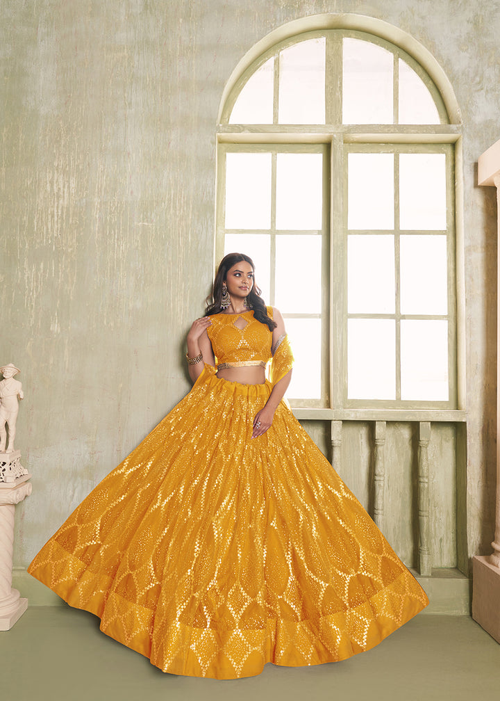 Buy Now Enchanting Mustard Net Wedding Festive Lehenga Choli Online in USA, UK, Canada, France, Italy, Germany, Sweden, Denmark &amp; Worldwide at Empress Clothing.