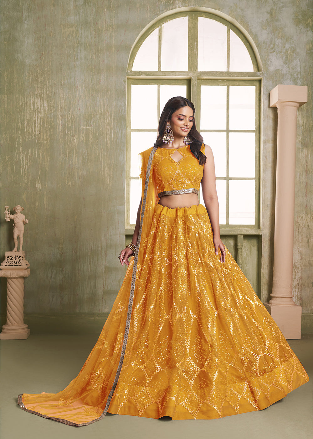 Buy Now Enchanting Mustard Net Wedding Festive Lehenga Choli Online in USA, UK, Canada, France, Italy, Germany, Sweden, Denmark &amp; Worldwide at Empress Clothing.