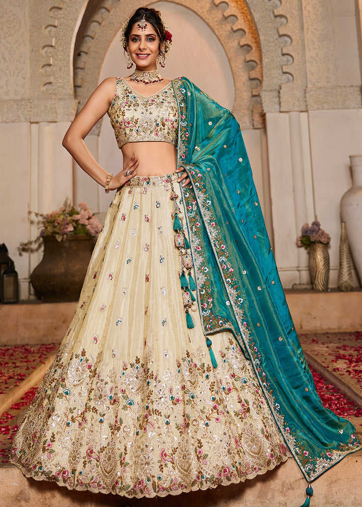 Buy Now Cream & Teal Heavy Embroidered Wedding Lehenga Choli Online in USA, UK, Canada, France, Italy, Germany, Austria, UAE & Worldwide at Empress Clothing.