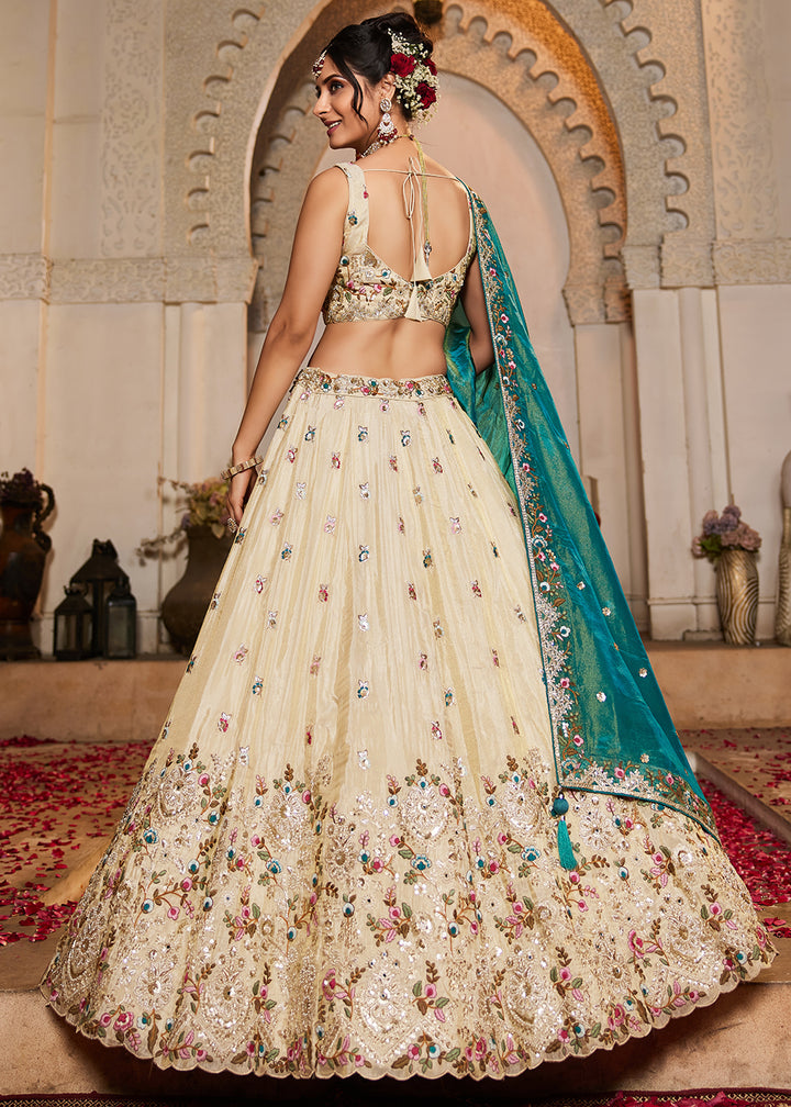 Buy Now Cream & Teal Heavy Embroidered Wedding Lehenga Choli Online in USA, UK, Canada, France, Italy, Germany, Austria, UAE & Worldwide at Empress Clothing.