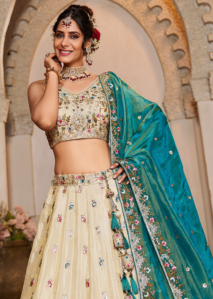 Buy Now Cream & Teal Heavy Embroidered Wedding Lehenga Choli Online in USA, UK, Canada, France, Italy, Germany, Austria, UAE & Worldwide at Empress Clothing.