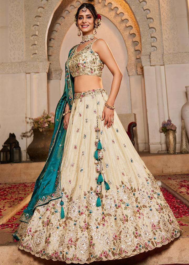 Buy Now Cream & Teal Heavy Embroidered Wedding Lehenga Choli Online in USA, UK, Canada, France, Italy, Germany, Austria, UAE & Worldwide at Empress Clothing.