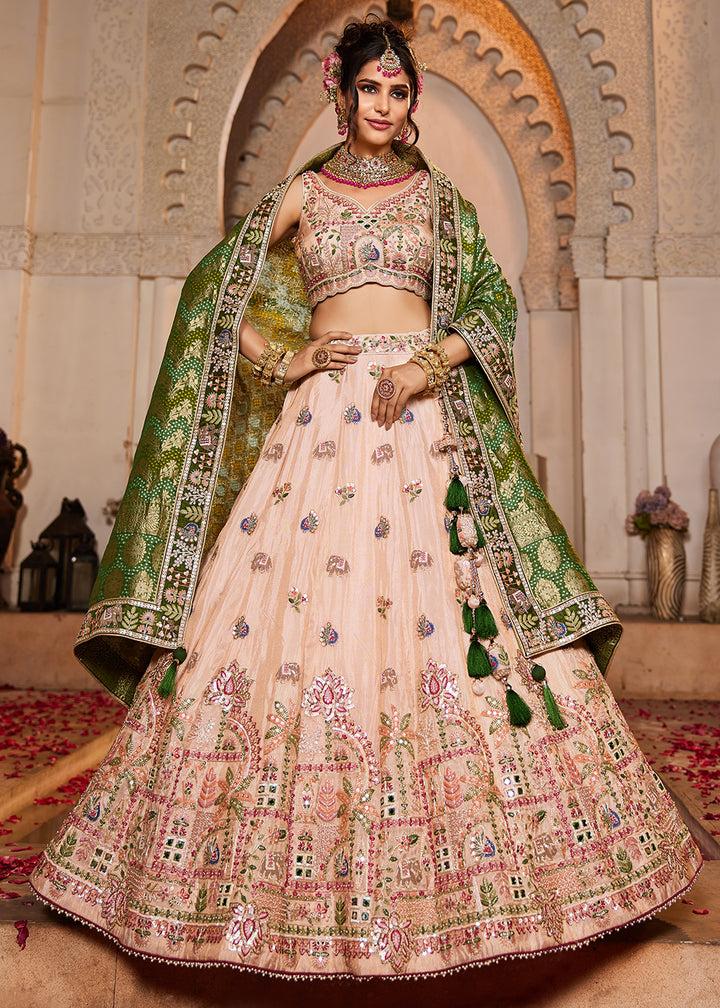 Buy Now Peach Tissue Mirror Embroidered Designer Lehenga Choli Online in USA, UK, Canada, France, Italy, Germany, Austria, UAE & Worldwide at Empress Clothing.