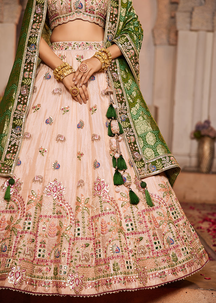 Buy Now Peach Tissue Mirror Embroidered Designer Lehenga Choli Online in USA, UK, Canada, France, Italy, Germany, Austria, UAE & Worldwide at Empress Clothing.
