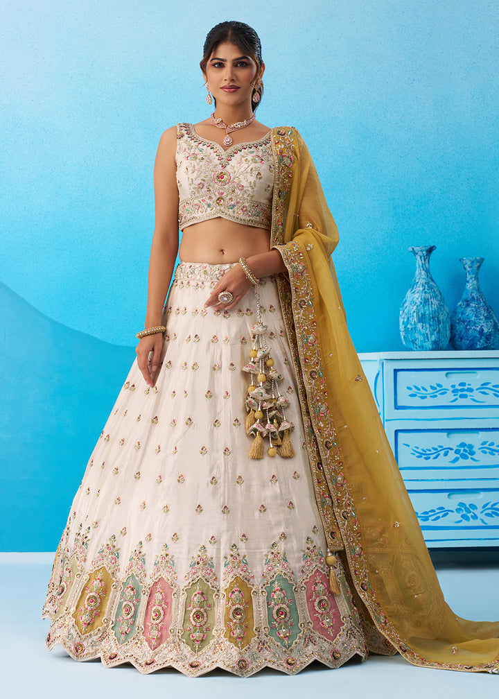 Buy Now Cream Multicolor Patch Work Lehenga Choli with Mustard Dupatta Online in US, UK, Canada, France, Italy, Germany, Sweden, Denmark & Worldwide at Empress.