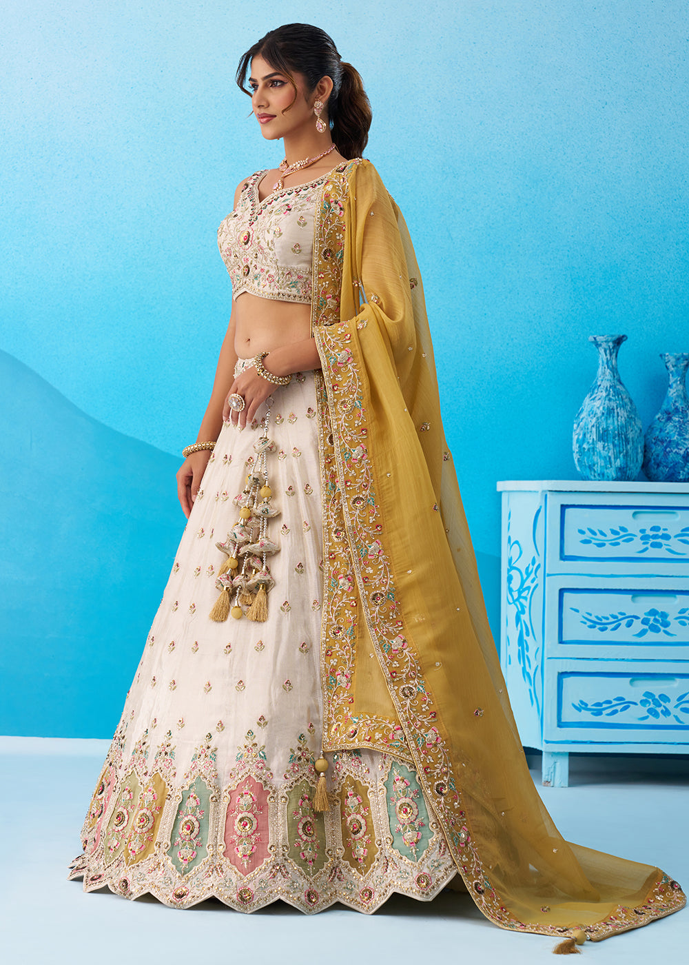 Buy Now Cream Multicolor Patch Work Lehenga Choli with Mustard Dupatta Online in US, UK, Canada, France, Italy, Germany, Sweden, Denmark & Worldwide at Empress.