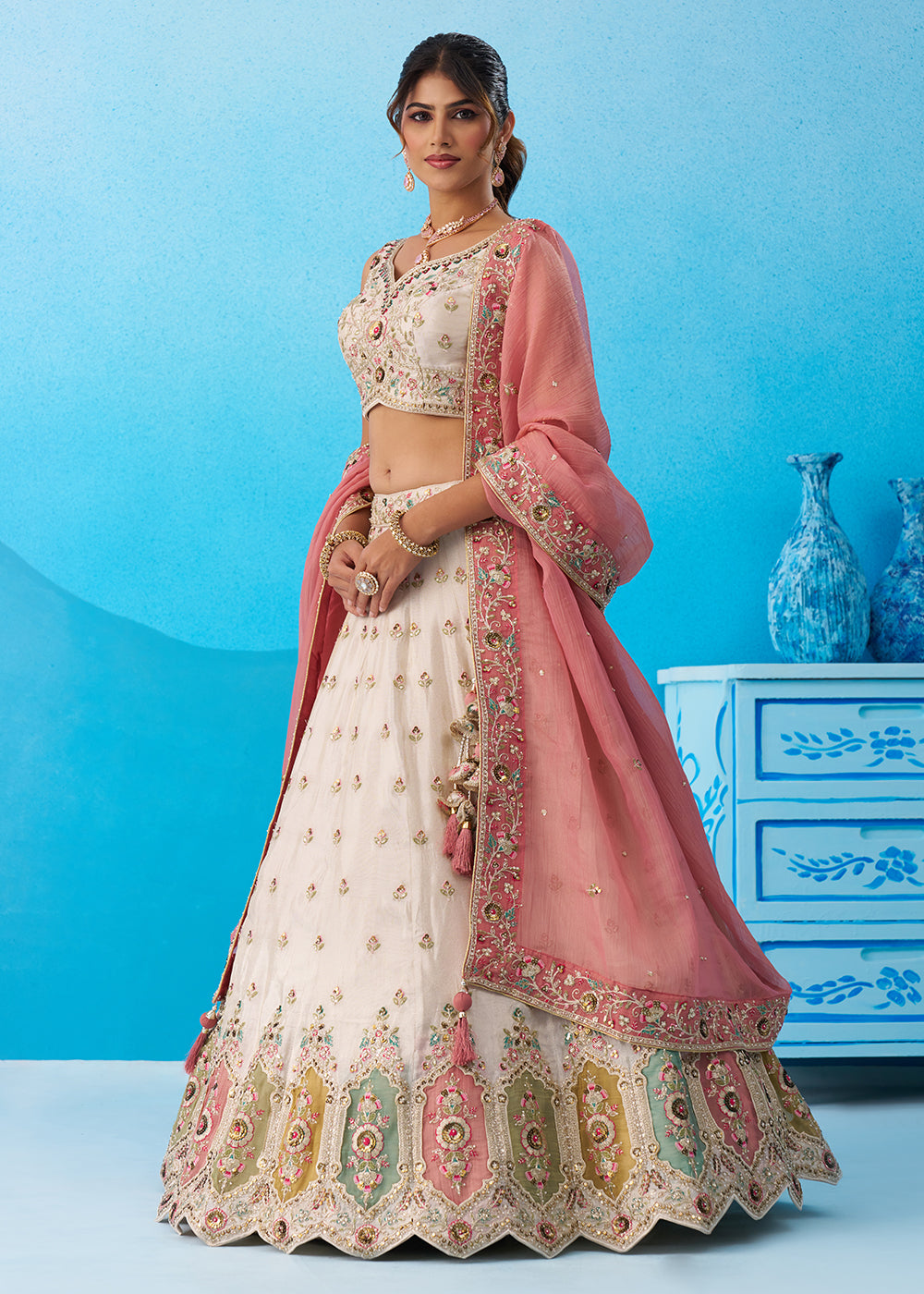 Buy Now Cream Multicolor Patch Work Lehenga Choli with Pink Dupatta Online in US, UK, Canada, France, Italy, Germany, Sweden, Denmark & Worldwide at Empress.