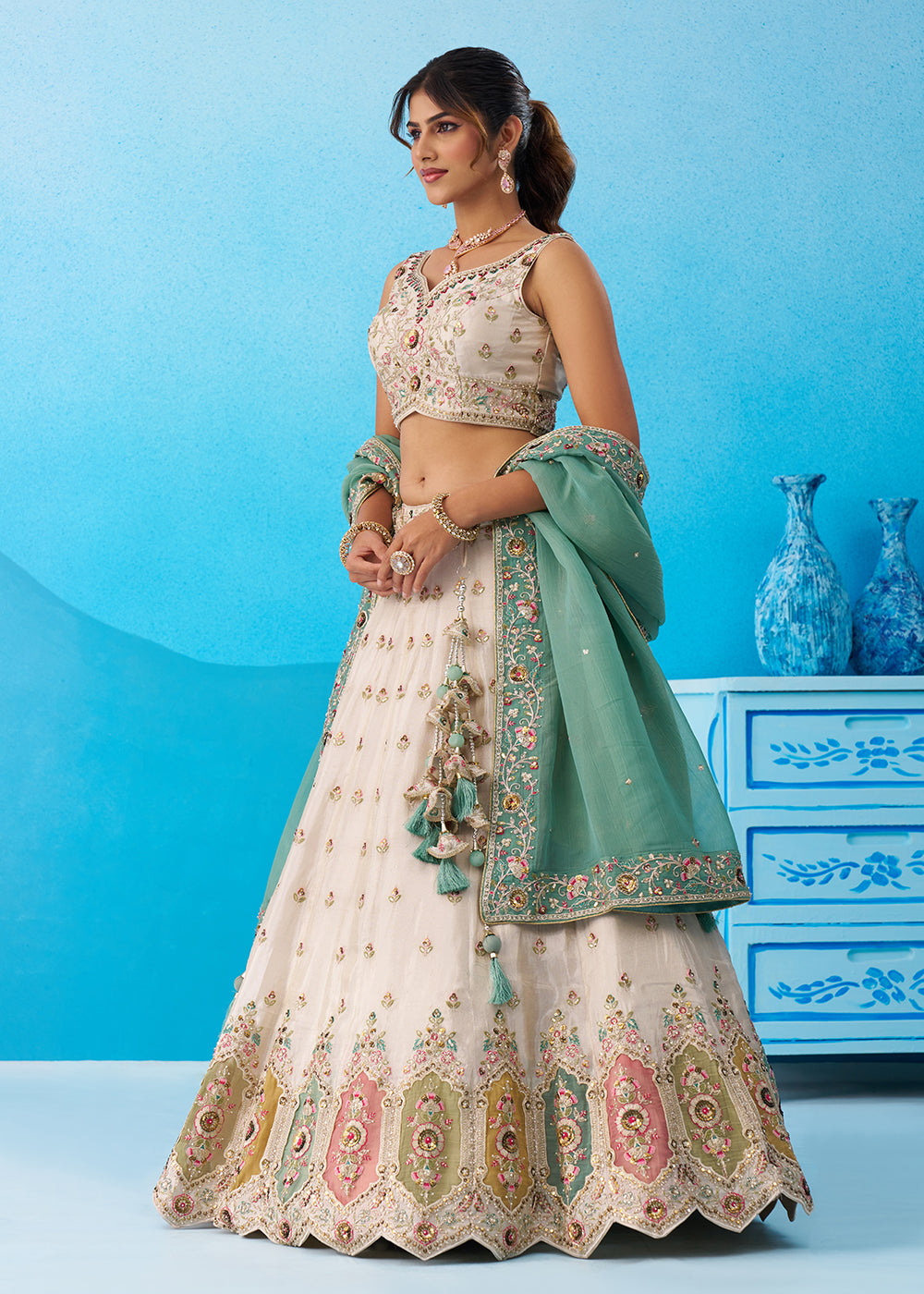 Buy Now Cream Multicolor Patch Work Lehenga Choli with Sky Dupatta Online in US, UK, Canada, France, Italy, Germany, Sweden, Denmark & Worldwide at Empress.