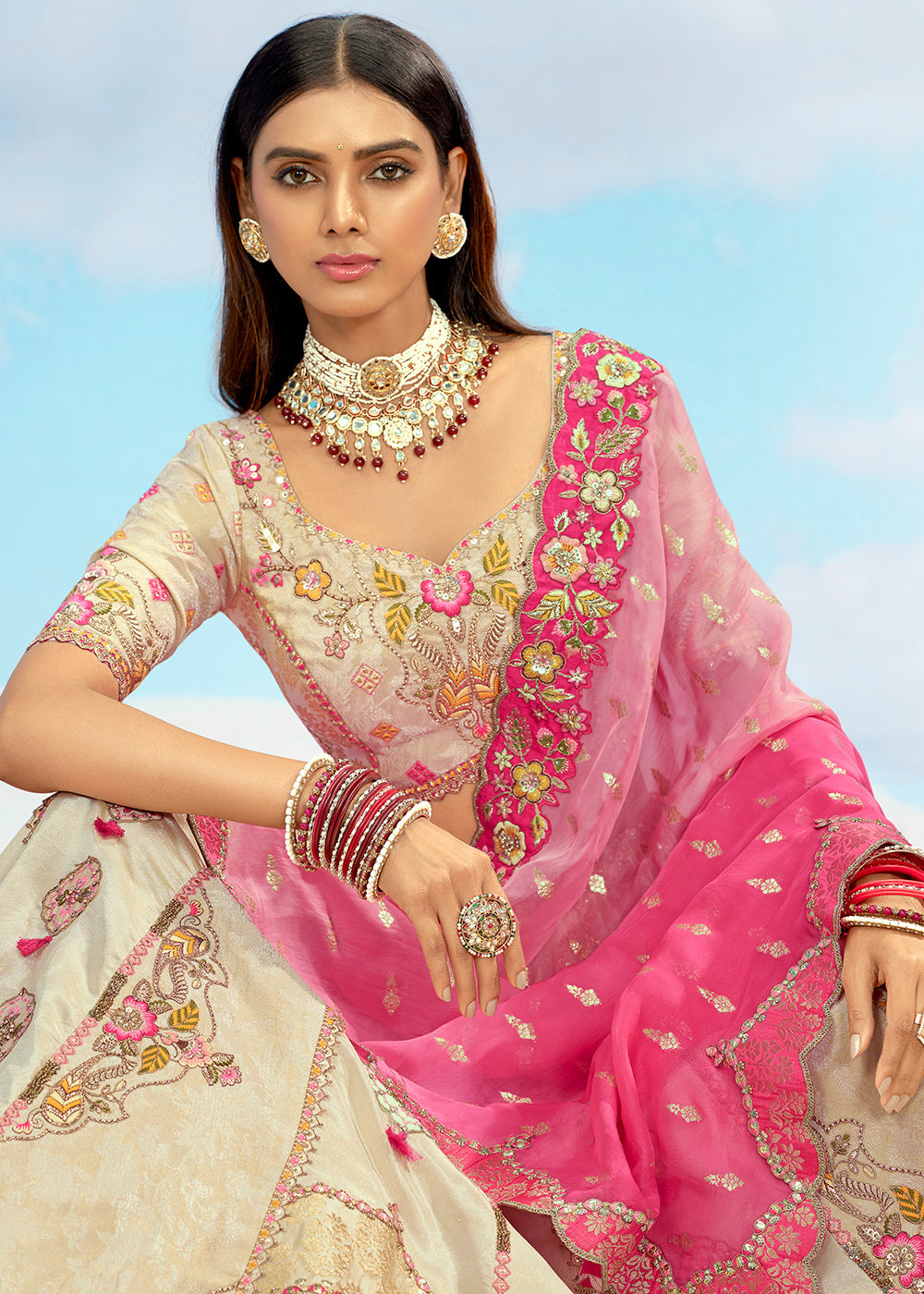 Buy Now Creamy Fancy Silk Heavy Embroidered Bridal Lehenga Choli Online in USA, UK, Canada, France, Italy, Germany, Austria, UAE & Worldwide at Empress.