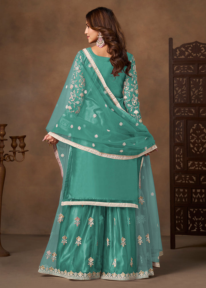 Shop Now Net Green Wedding Embroidered Gharara Style Suit Online at Empress in USA, UK, Canada, Germany, Australia, Sweden, Denmark, UAE, Qatar & Worldwide.