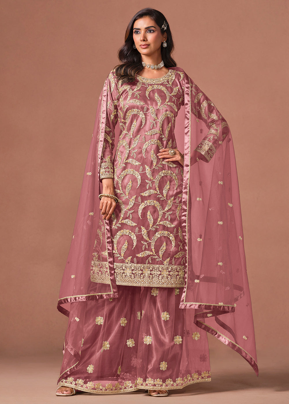 Shop Now Pink Net Beautifully Embroidered Wedding Party Sharara Suit Online at Empress in US, UK, Canada, Italy, Germany, France, Greece, Sweden, UAE, Denmark & Worldwide.