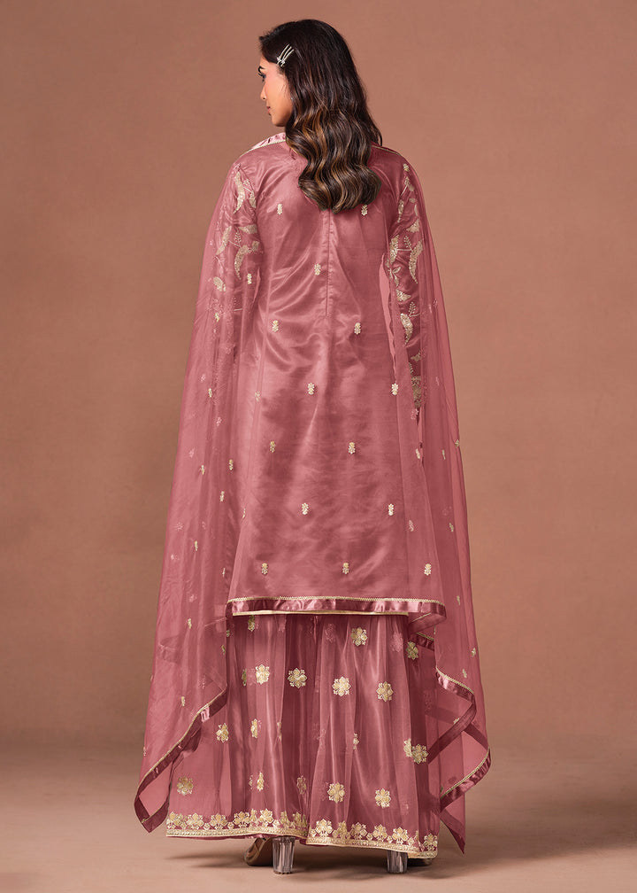 Shop Now Pink Net Beautifully Embroidered Wedding Party Sharara Suit Online at Empress in US, UK, Canada, Italy, Germany, France, Greece, Sweden, UAE, Denmark &amp; Worldwide.