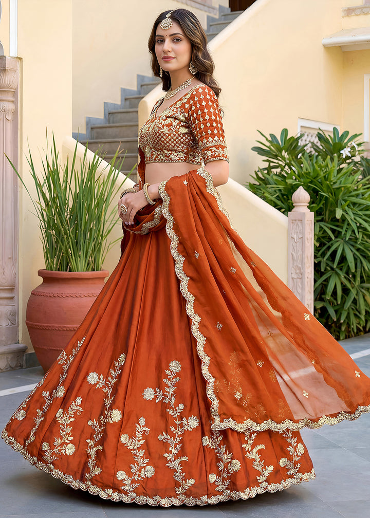 Buy Now Orange Rangoli Silk Zari &amp; Threads Festive Lehenga Choli Online in US, UK, Canada, France, Italy, Germany, Sweden, UAE &amp; Worldwide at Empress Clothing.